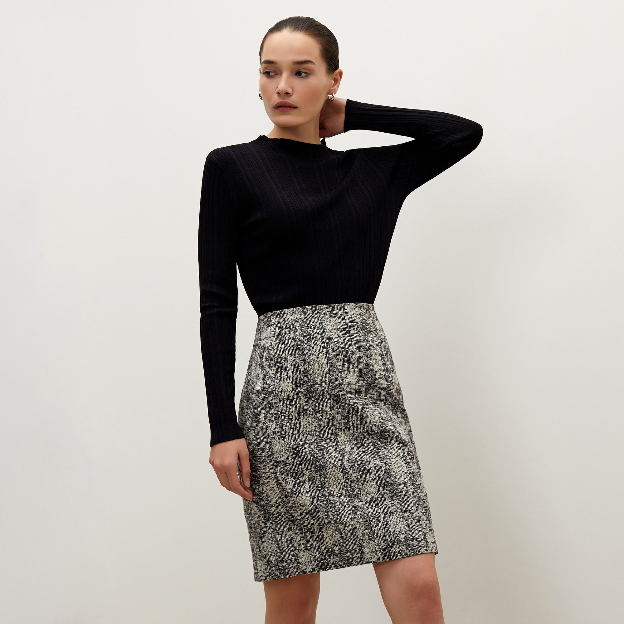Front image of a woman standing wearing the Noho skirt in crackle | Exclude