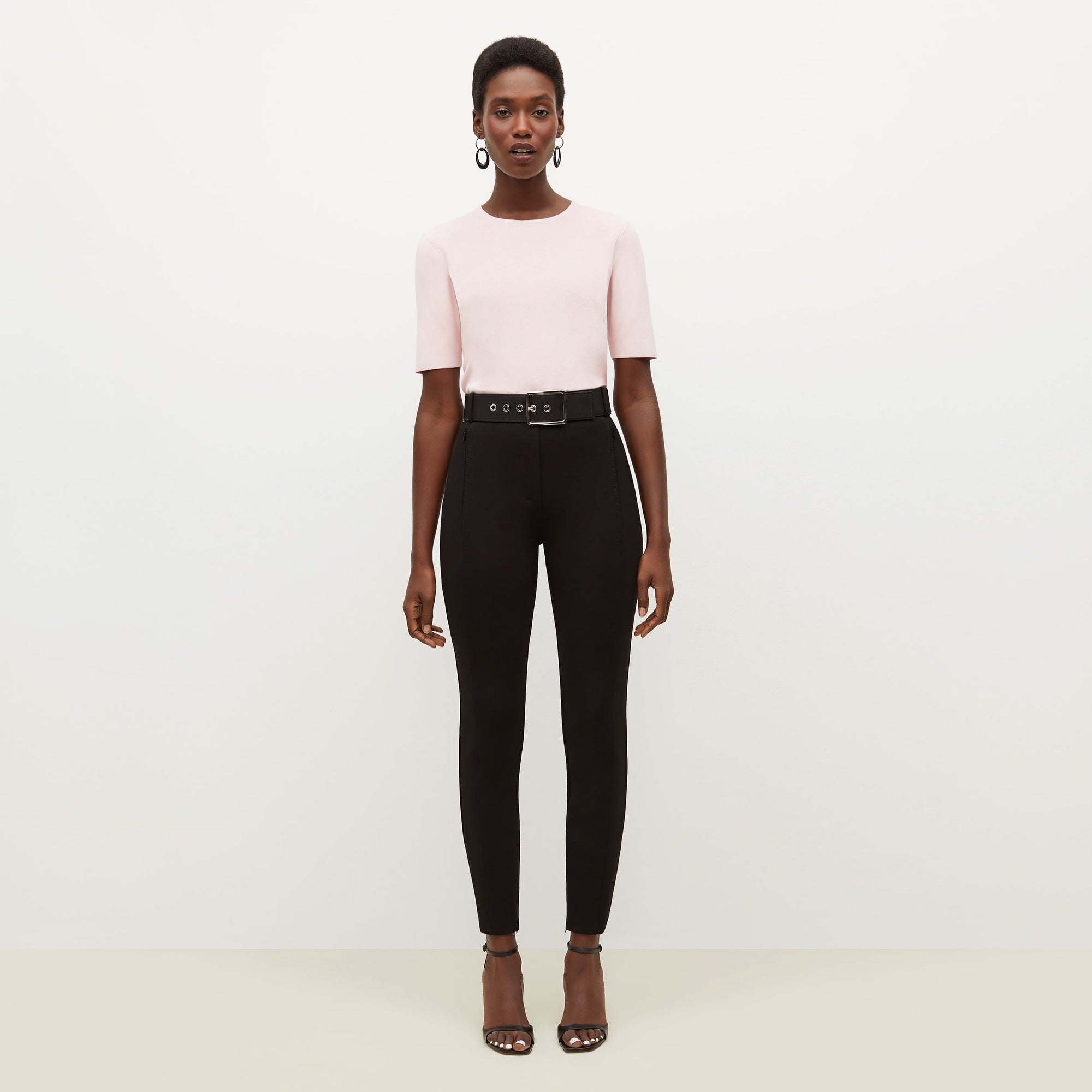 Front image of a woman standing wearing the Curie Pant--Worth in Black