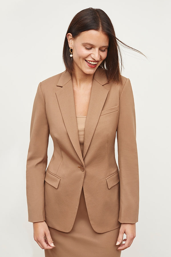 Front image of a woman standing wearing the Yiyan Blazer in Camel | Exclude