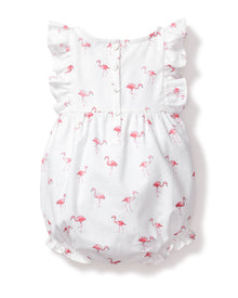 The Petite Plume Babys Twill Ruffled Romper in Flamingos combines charm and comfort with its playful pink flamingo print, white fabric, ruffled sleeves, and hem. It features back buttons, perfect for those seeking tropical pajama vibes for their little ones.