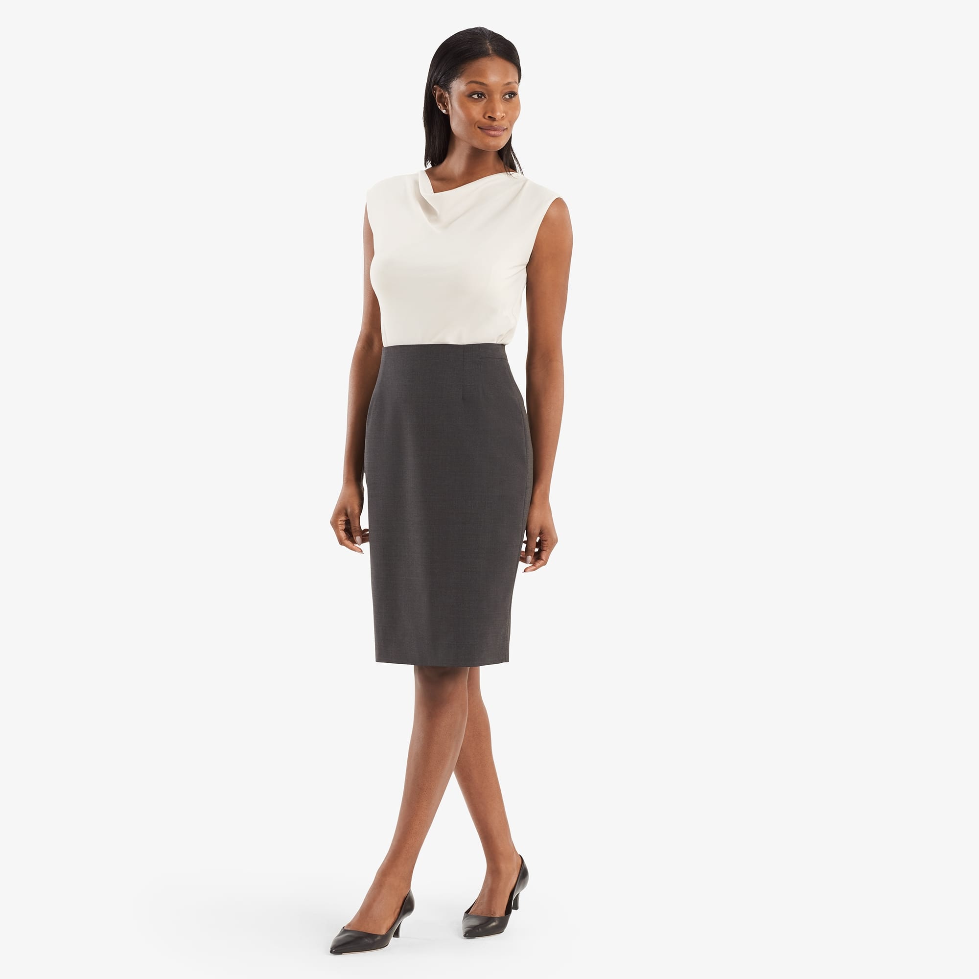 Hero image of a woman posing wearing the Cobble Hill skirt in gray melange and the Rowling top in birch. | Exclude
