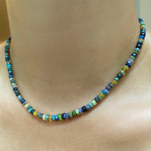 Shimmering beaded necklace made of faceted opals in shades of green, yellow, and blue on a gold linking ovals clasp.