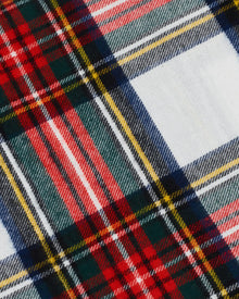 Close-up of Petite Plumes Flannel Sheets in Balmoral Tartan, featuring a vibrant crisscross pattern with intersecting lines in red, green, yellow, navy, and white.