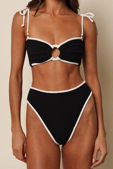 Black terry bikini bottom with cream-colored binding and high-leg cut.