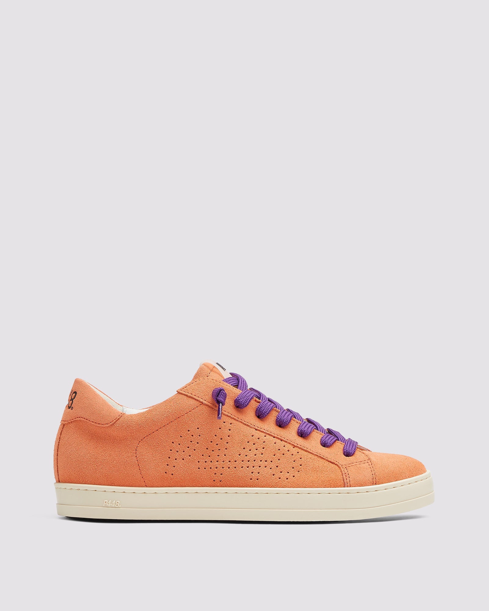 Bottom angle of the left blue sneaker with yellow laces and right orange sneaker with purple laces
