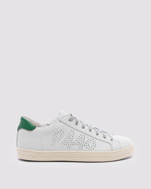 Side angle of white and  green sneakers