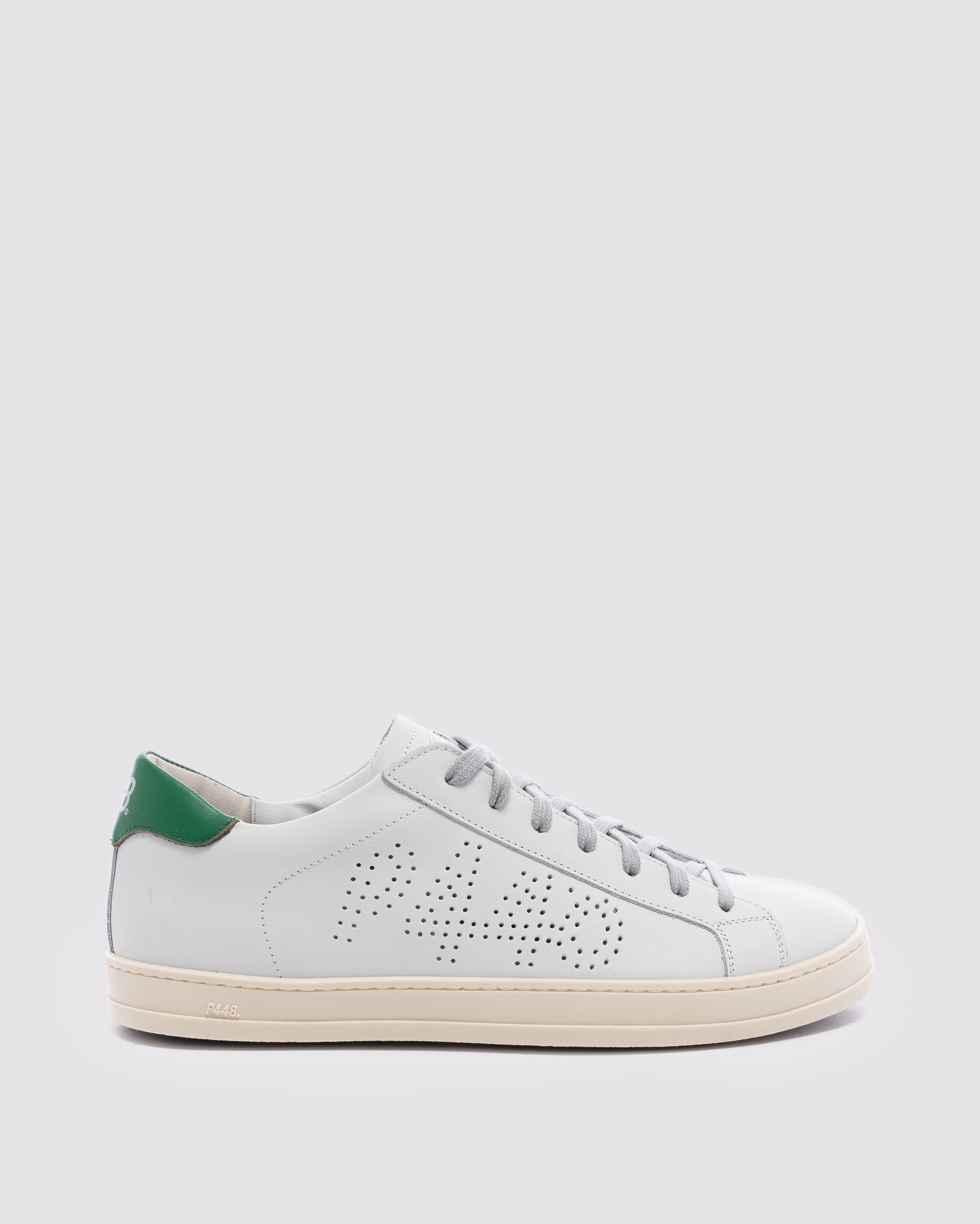 Side angle of white and  green sneakers