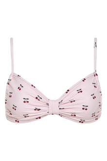 Pink bikini top with red and black cherry print, twisted center detail, and thin shoulder straps.