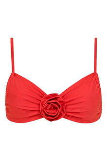 Red bikini top with ruched fabric, thin shoulder straps, and a three-dimensional rose flower detail at the center front.