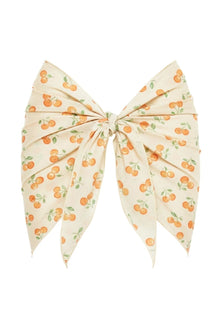 Cream sarong with orange cherry print and green leaves, tied at center with pointed ends.