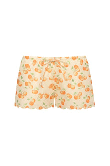Cream shorts with orange cherry and green leaf print, scalloped edges, and orange drawstring at waist.