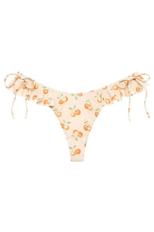 Cream bikini bottom with orange cherry print and ruffled edges, tied with cream-colored bows at the sides.
