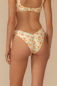 Cream bikini bottom with orange cherry and green leaf print, zig-zag waistband detail.
