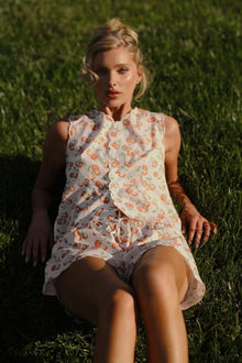Cream short with cherry print pattern and scalloped edges, shown with drawstring waistband.
