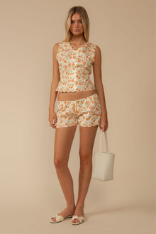 Cherry print shorts with scalloped edges, drawstring waist, and matching sleeveless top with scalloped trim.