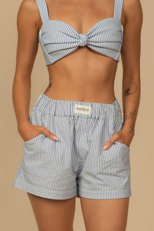 Blue and white striped boxer shorts with elastic waistband and side pockets.