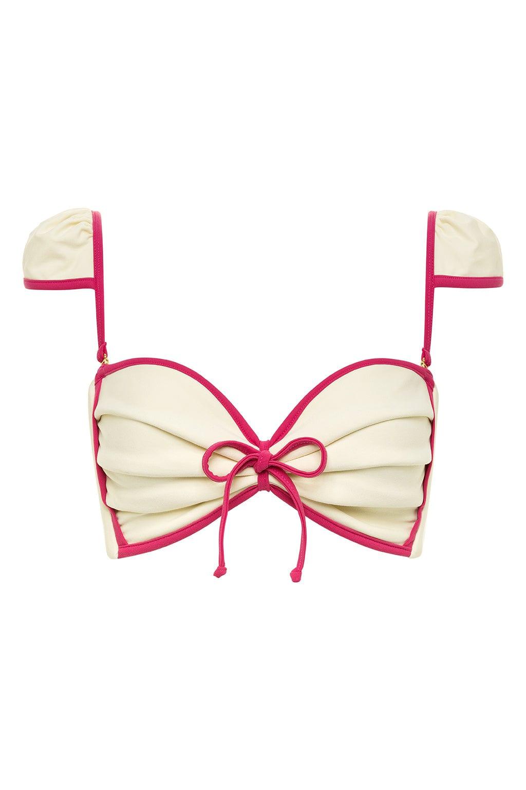 Cream and raspberry bikini top with bow-shaped cups, raspberry binding, and adjustable shoulder straps with bow details.
