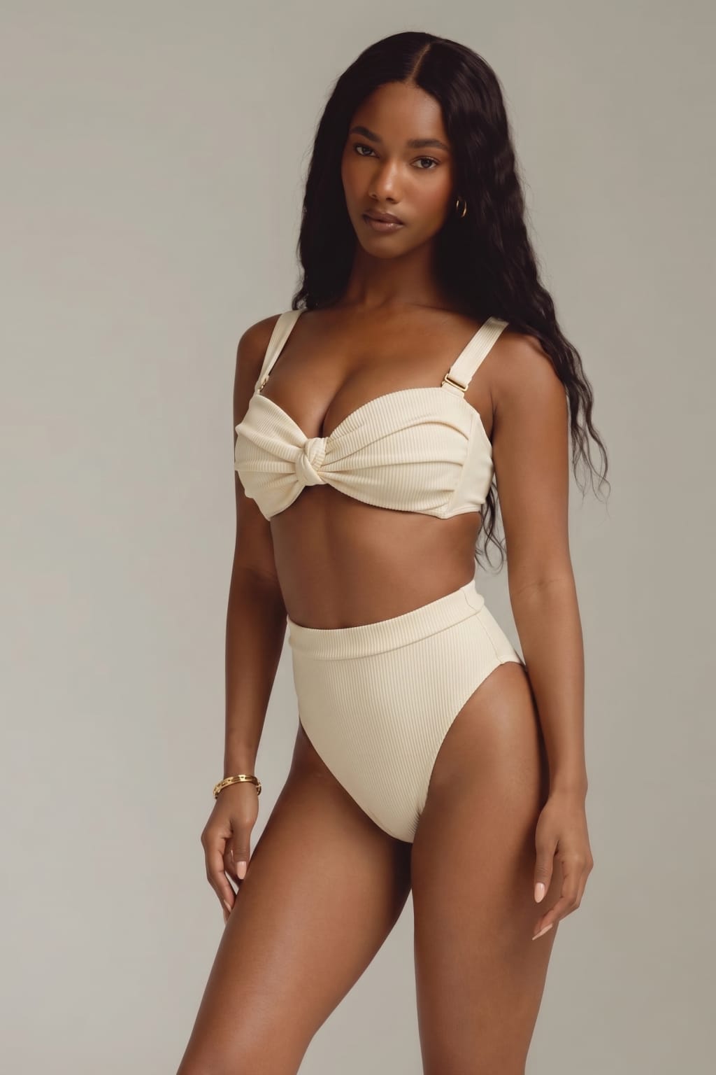 Cream ribbed bikini bottom with high-waisted fit and side cutouts, shown on model with matching top.