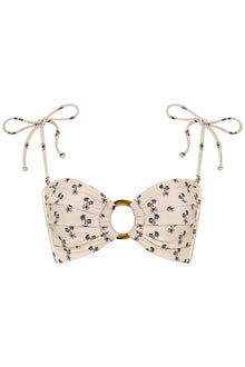 Cream bandeau bikini top with small dark floral print, gold ring detail at center, and beige tie straps with decorative beads