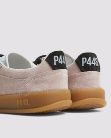 Side angle of light pink and black sneakers