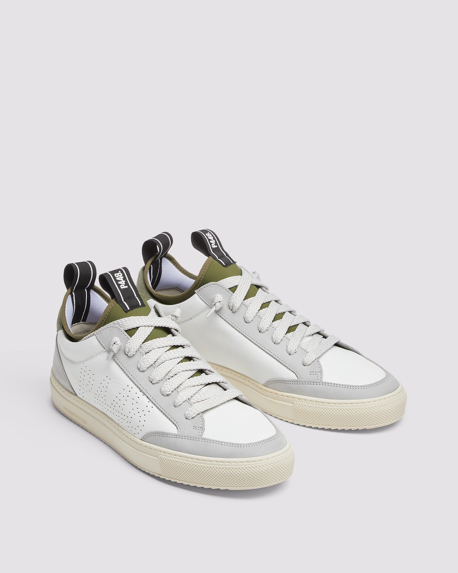 Back angle of white, grey and green sneakers
