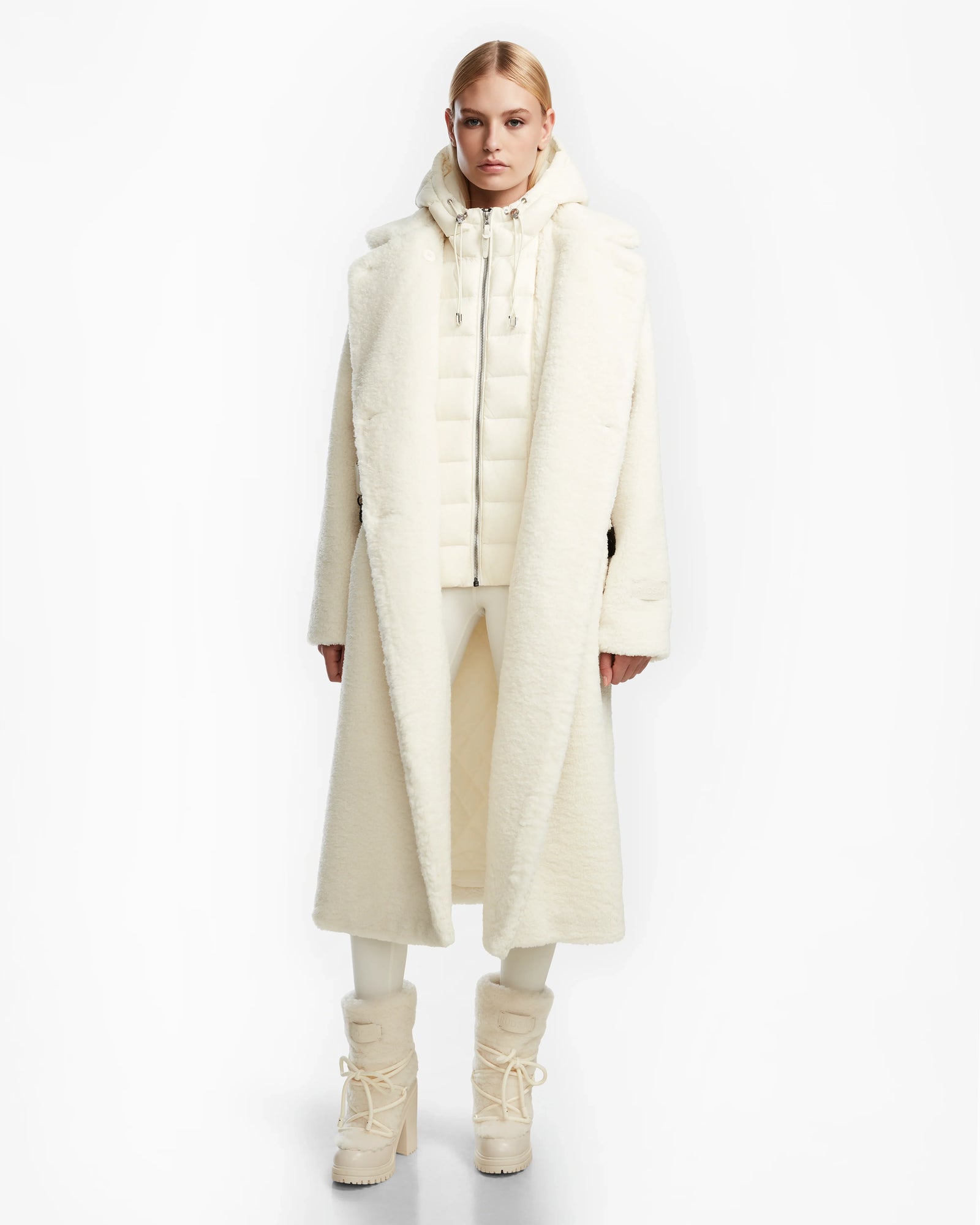 A person wearing the Rudsak TINA - 8123578 Iceland womens trench coat featuring a removable hooded bib.