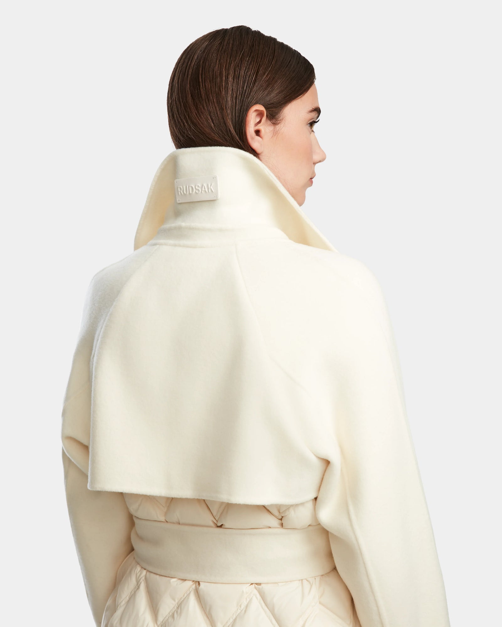 A woman in the ZOE - 8124711 Iceland long trench coat by Rudsak.