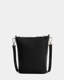 The Rudsak LILA - L325513 Black is a small women's crossbody bag in pebbled leather with silver hardware and an adjustable, detachable strap, displayed against a white background.
