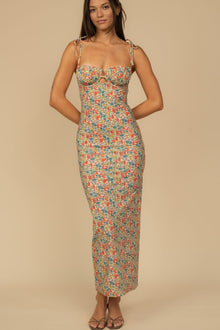 Long slip dress with multicolored floral print, sweetheart neckline, adjustable straps, and cutout detail at bust.