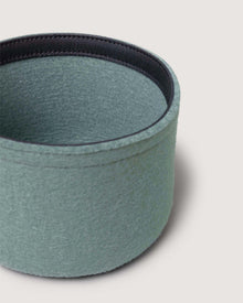 A round, light green Merino wool bin by Graf Lantz, featuring a black inner rim and shown against a plain light background—a stylish and sustainable organizer for your space.