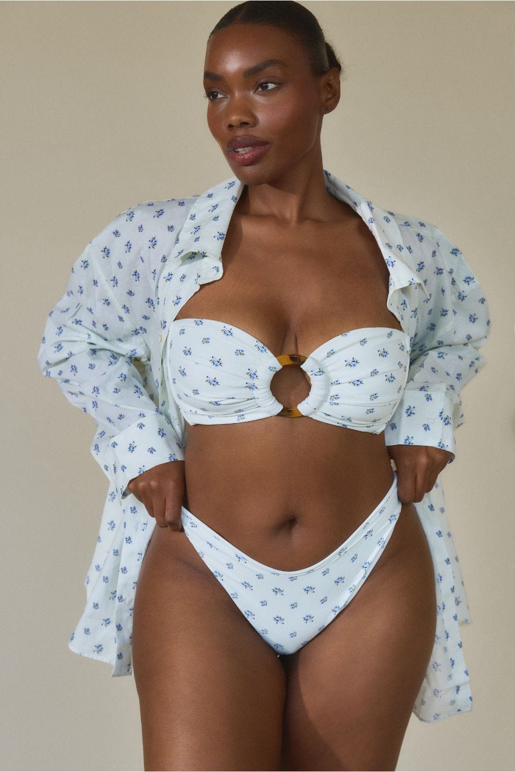 White bikini bottom with small blue floral print and high-cut leg openings.
