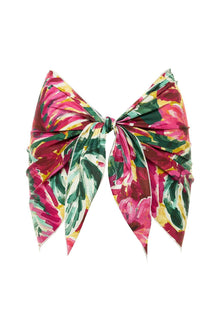 Colorful floral sarong with pink, yellow, and green botanical print, tied at center with pointed ends.
