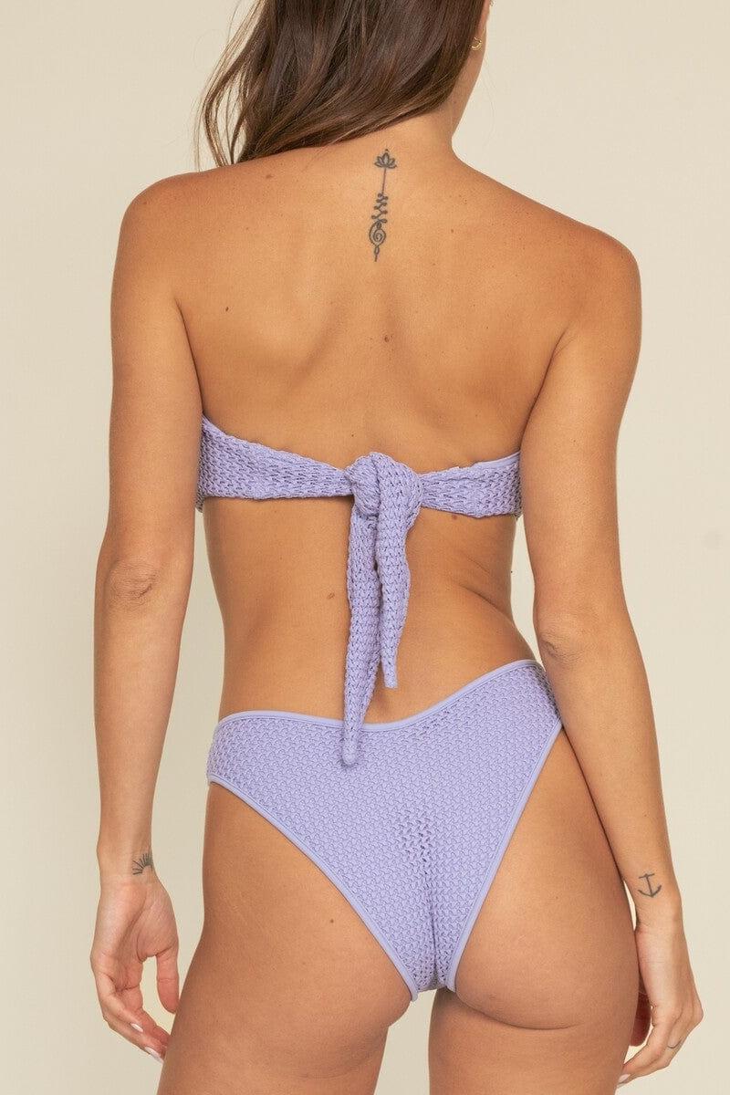 Lavender crochet bikini bottom with textured fabric and tie-side detail, shown from back view.