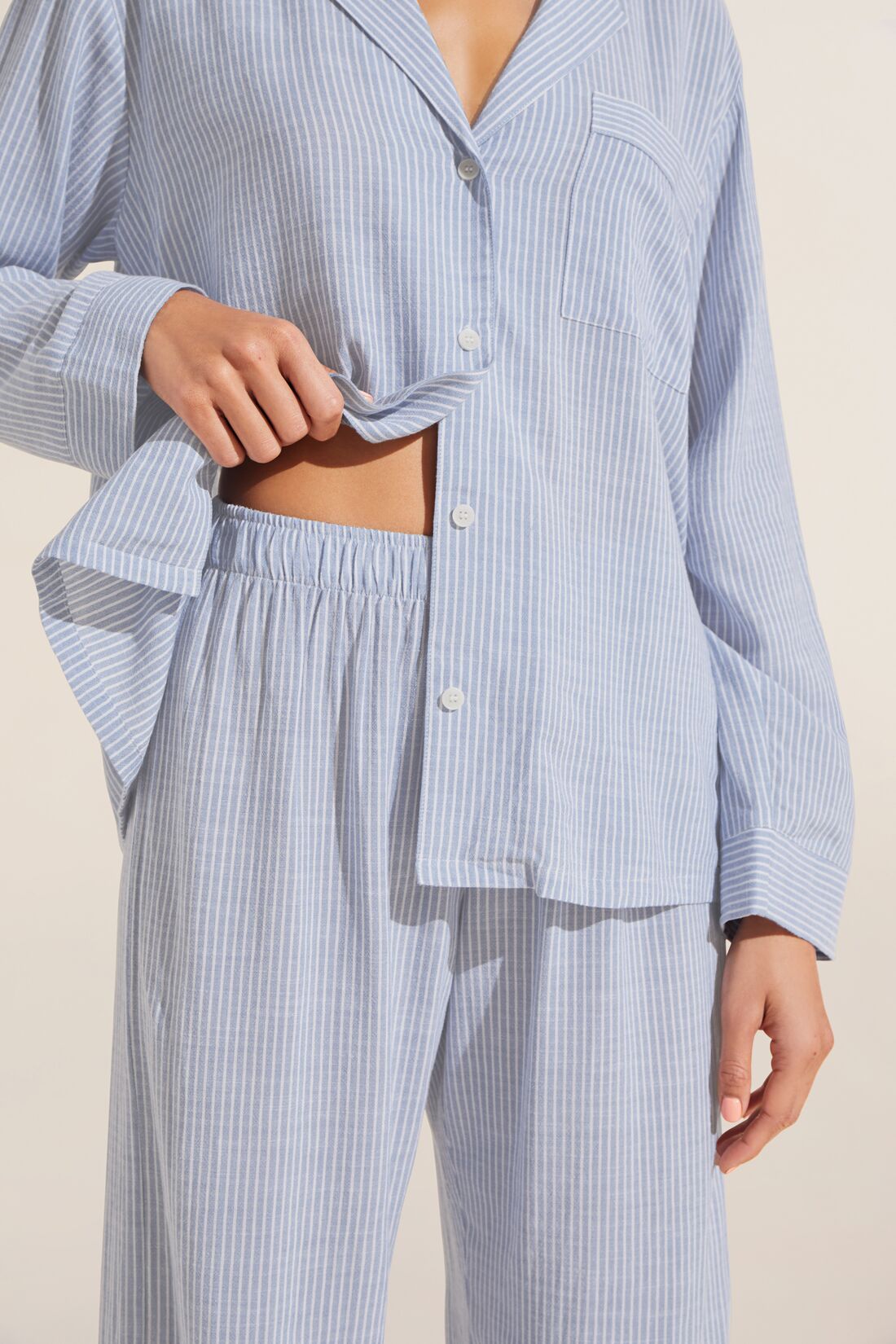 Model is wearing Nautico Long PJ Set in Wedgewood Blue/White.