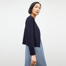 Side image of a woman wearing the sant ambroeus jardigan in navy