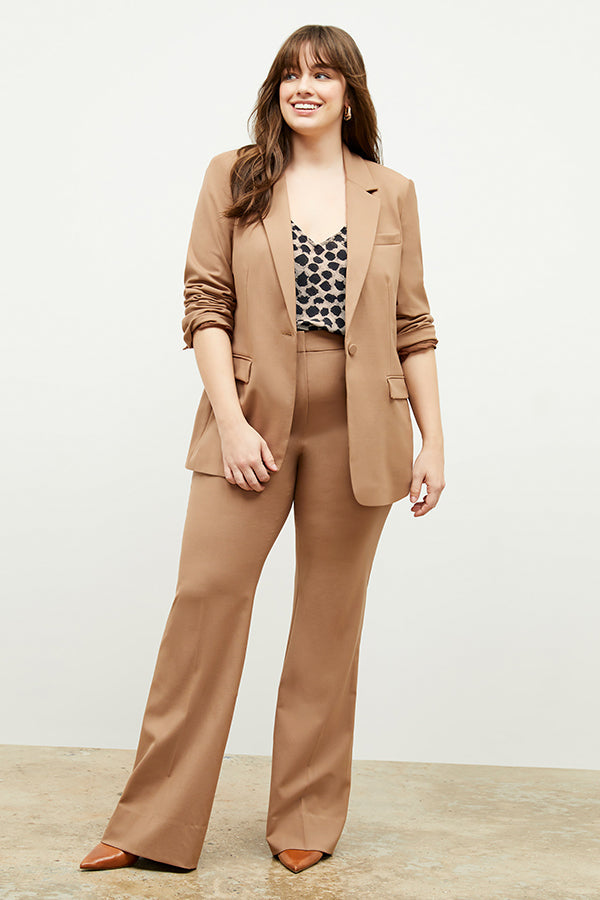 Front image of a woman standing wearing the Yiyan Blazer in Camel | Exclude