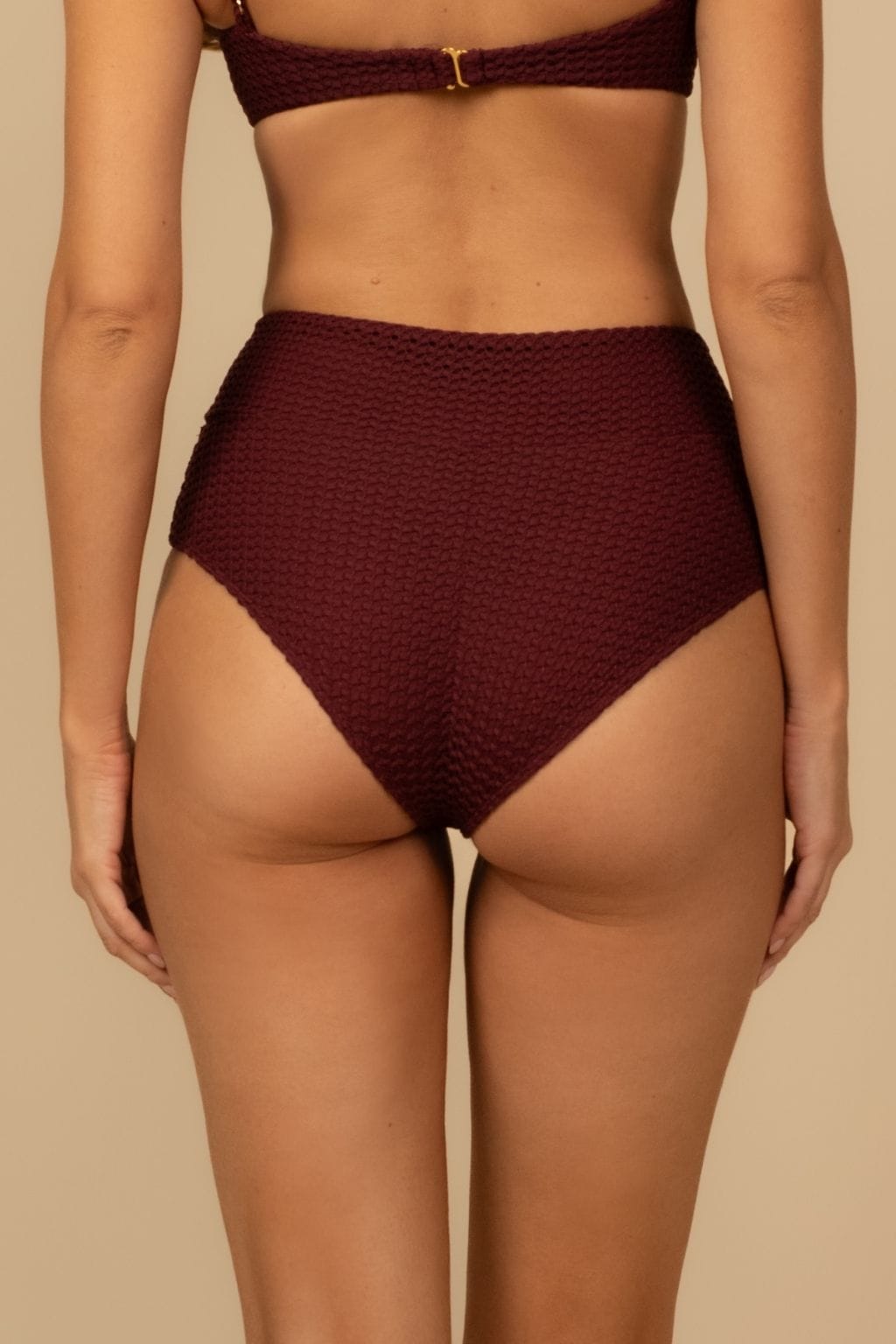 Maroon crochet high-rise bikini bottom with textured pattern and gold clasp detail at center front.