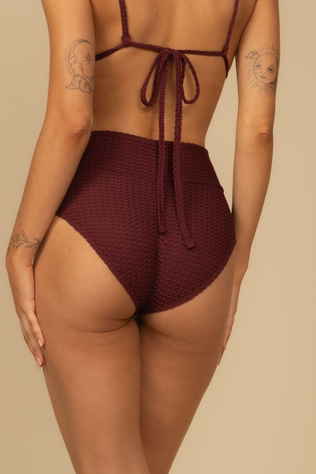 Maroon crochet bikini bottom with high-rise waistband and tie back closure shown from rear view.