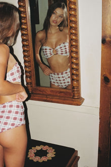 Maroon and white plaid bikini bottom with bow detail at center front.