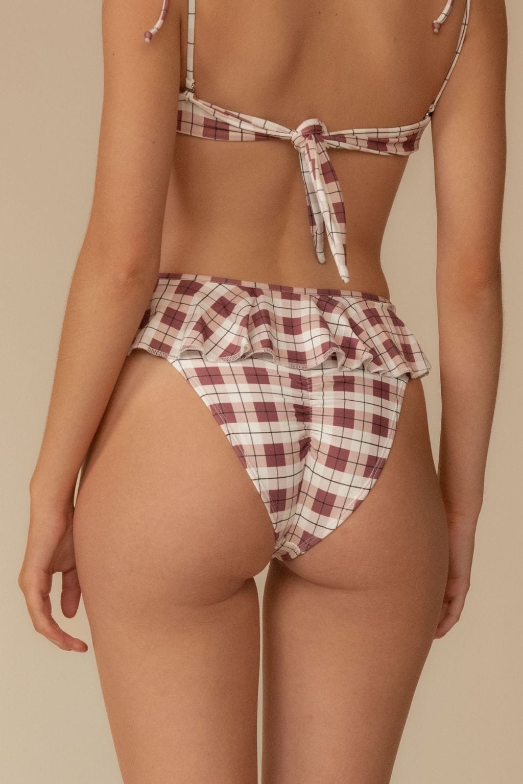 Maroon and cream plaid bikini bottom with ruffle detail at leg openings.