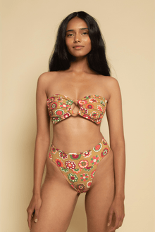 Tan bikini bottom with red, green, and yellow floral pattern and bound waistband.