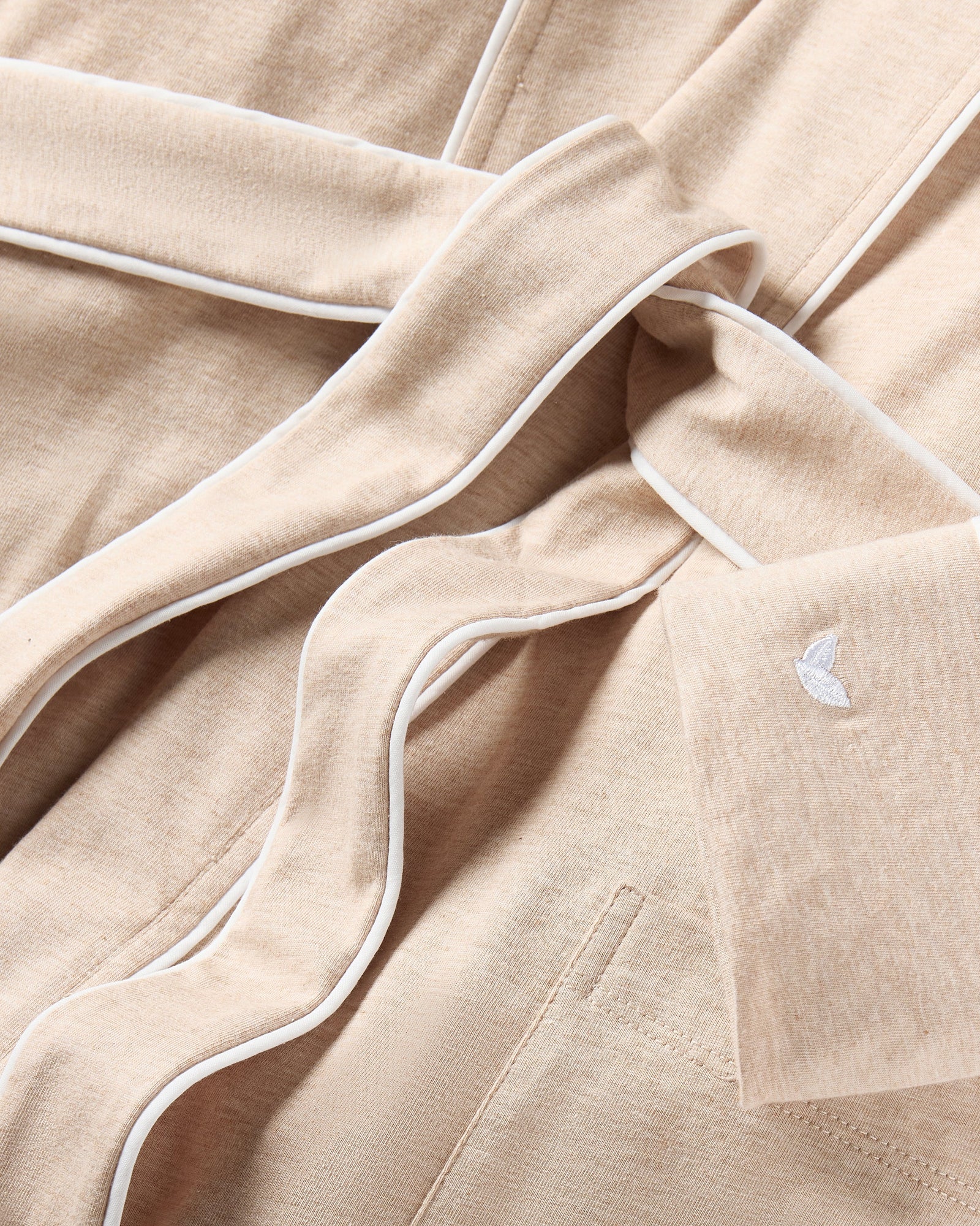 The Women's Pima Robe in Camel features white trim, long sleeves, two front pockets, and a matching waist belt, shown on a white background.