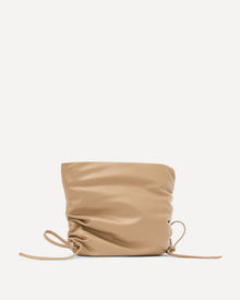 Beige drawstring bag on a light beige background