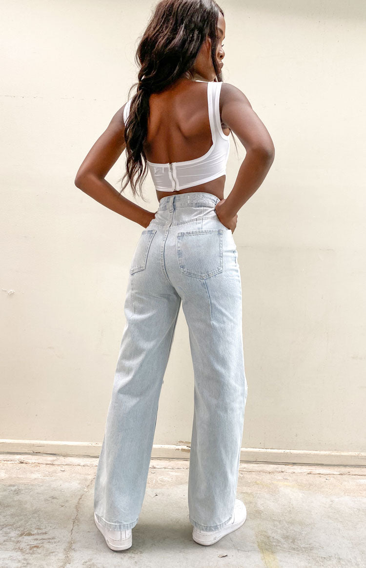 Light blue wide leg jeans, high-waisted with back pockets and vertical seams down the legs