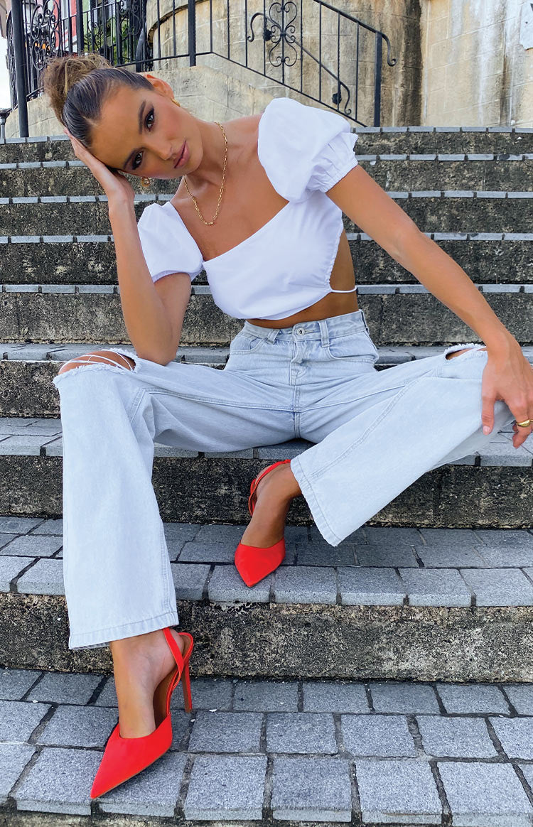 Pale blue high waisted wide leg jeans with distressed knee rips