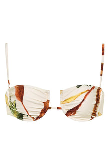 Cream bikini top with floral print in rust, gold, and green tones, featuring thin shoulder straps and ruched cup detail.