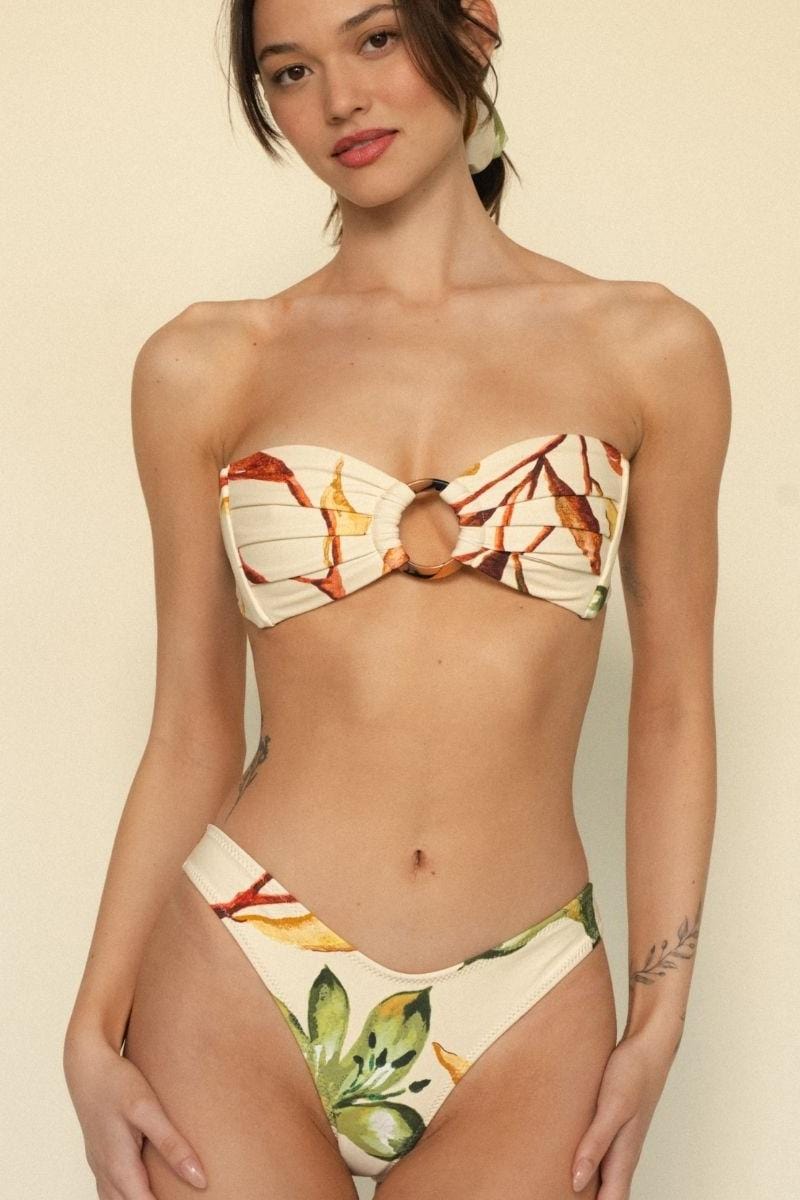 Cream bikini bottom with red and yellow floral print and zig-zag stitching detail.