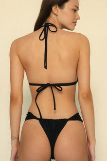 Black halter bikini top with tie closures at neck and back, shown from behind on model.