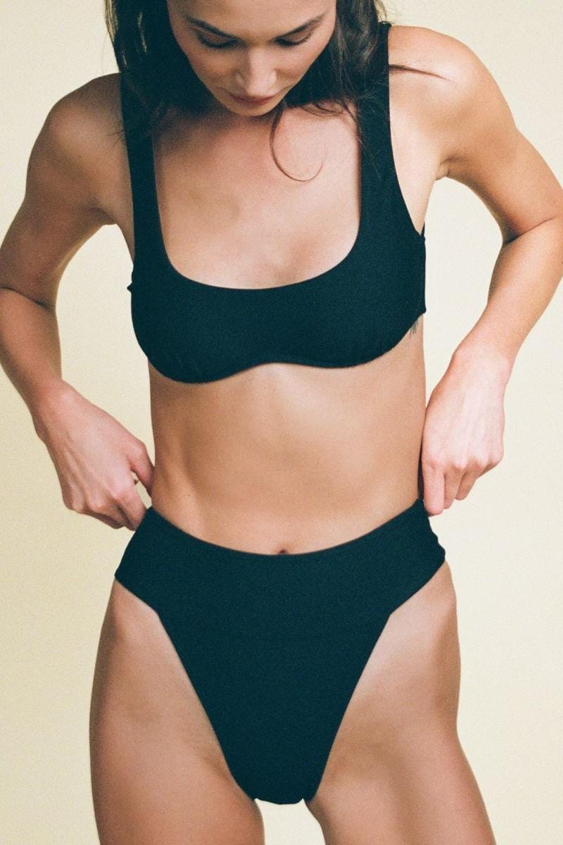 Black bikini bottom with high-cut legs and minimal coverage design.