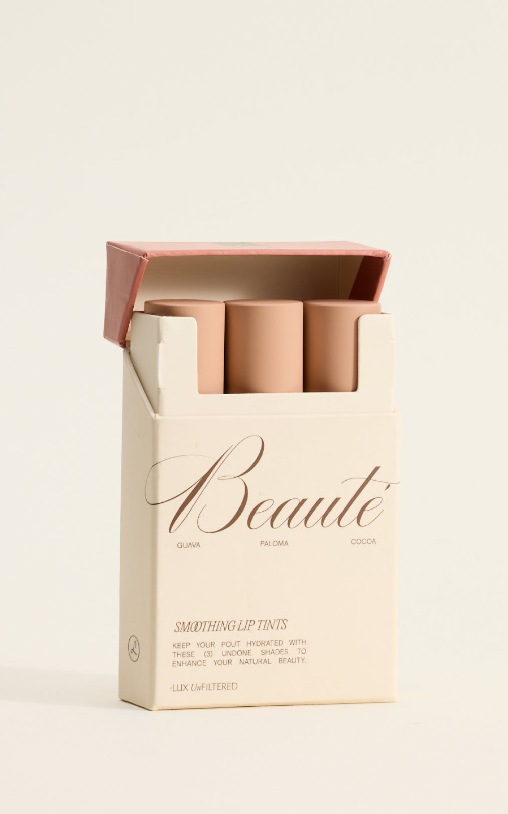 Box of three nude-pink lip tints labeled 'Beauté' with shade names Guava, Paloma, Cocoa and 'Smoothing Lip Tints'.